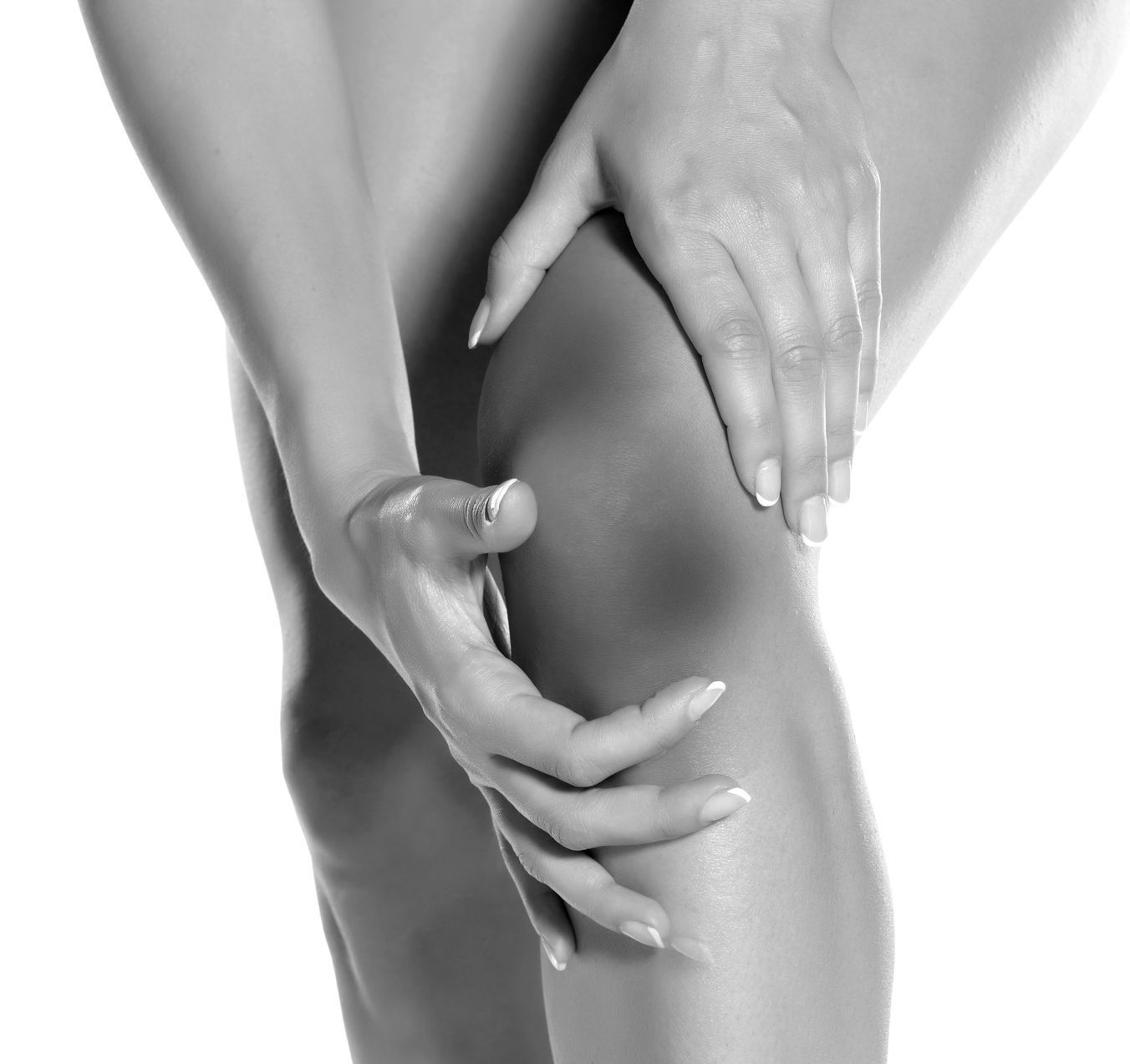 A person holding their knee, indicating pain or injury.