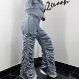 Washed denim jeans with worn edges and holes