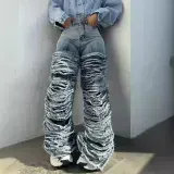 Washed denim jeans with worn edges and holes