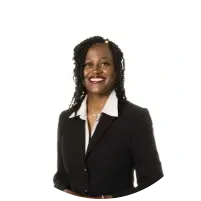 a woman in a black suit and white shirt is smiling .