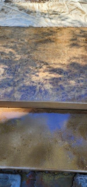 Shadows on a textured stone surface, possibly stairs, with light reflecting off the edges.