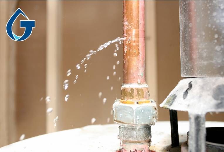 A copper pipe is leaking water from it.