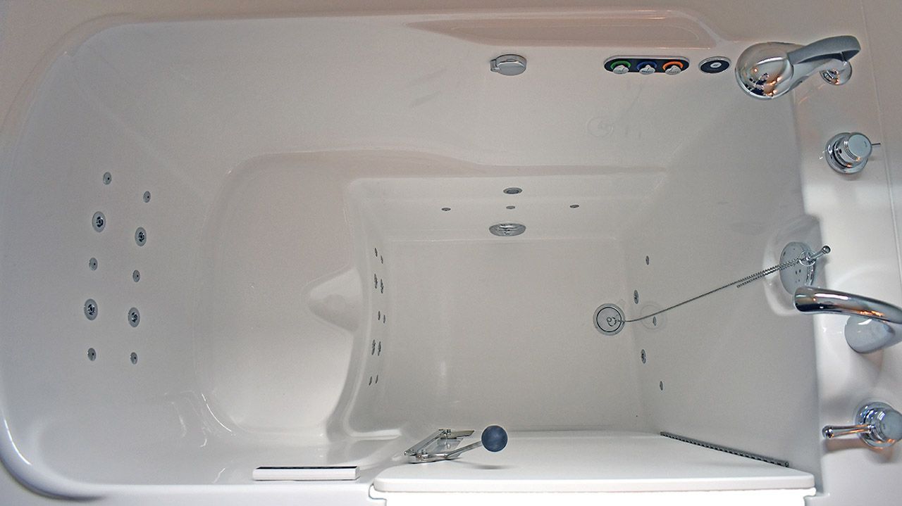 A white bathtub with a lot of bubbles in it