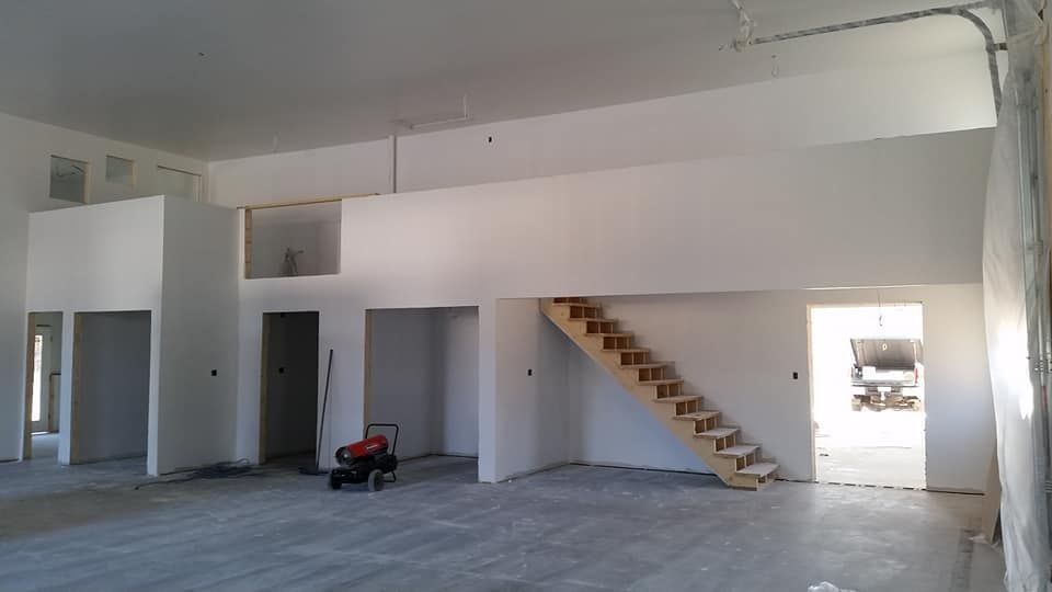 An empty room with a staircase in the middle of it
