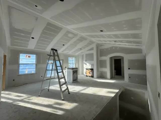 An empty room with a ladder in the middle of it