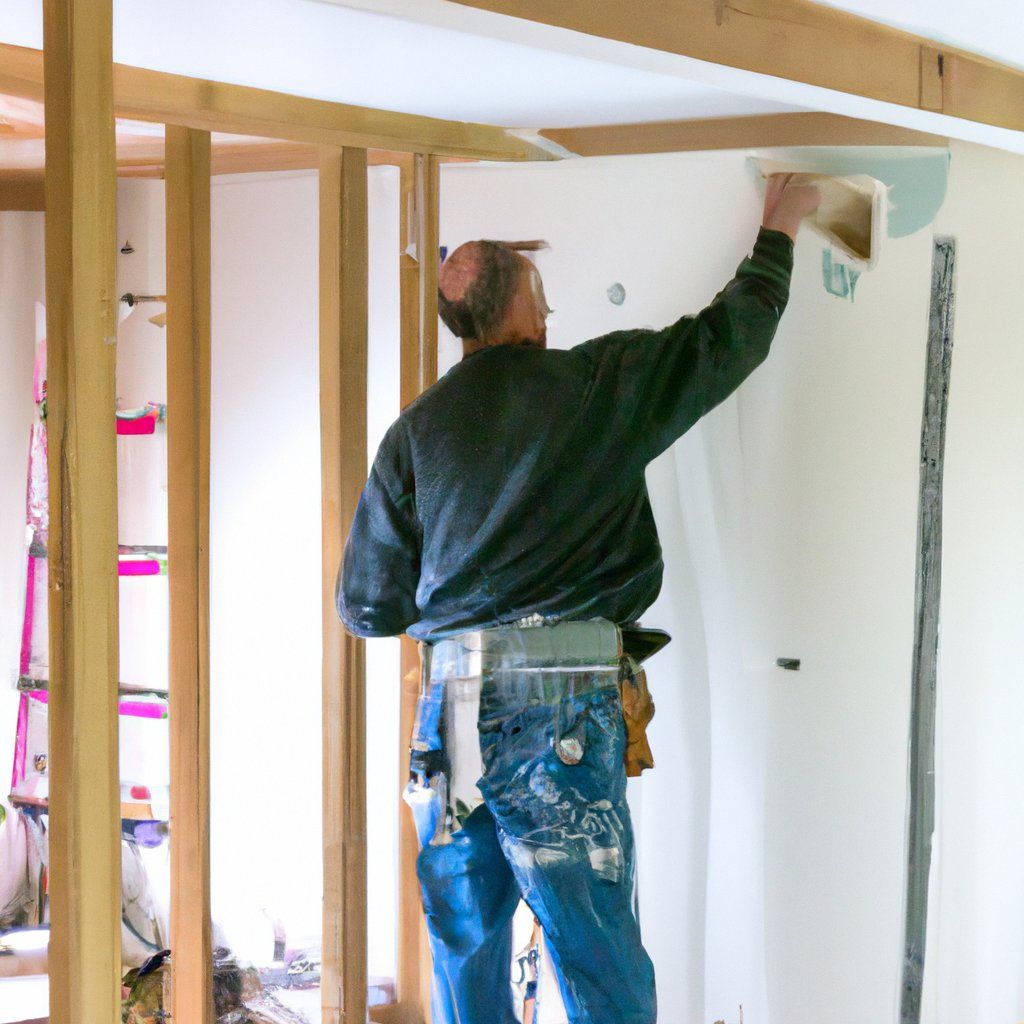 A man in a black sweater and blue jeans is working on a wall