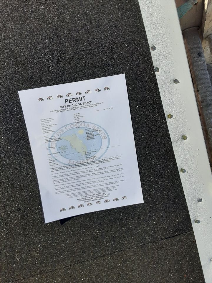 Printed notice taped to a dark textured surface, with a small globe graphic and text.