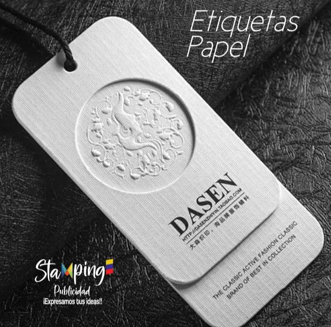 Etiqueta metálica colgante para papel con diseño circular en relieve y logotipo de DASEN sobre fondo oscuro texturizado.