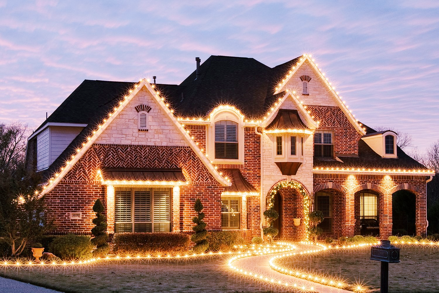 Christmas lights decorating roofline of home in Houston