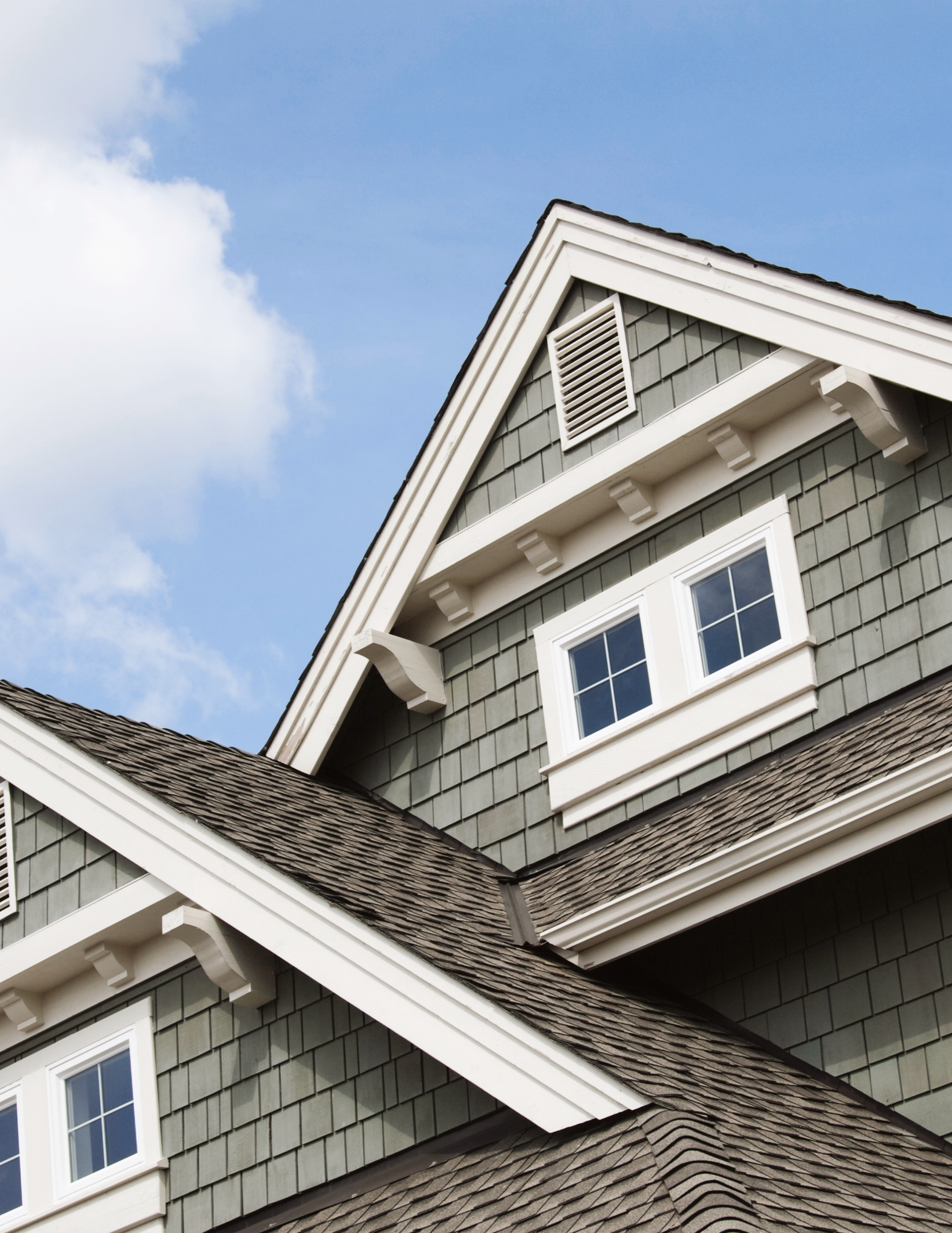 Professional pressure washing cleaning the siding of a Houston home, removing dirt and grime for imp