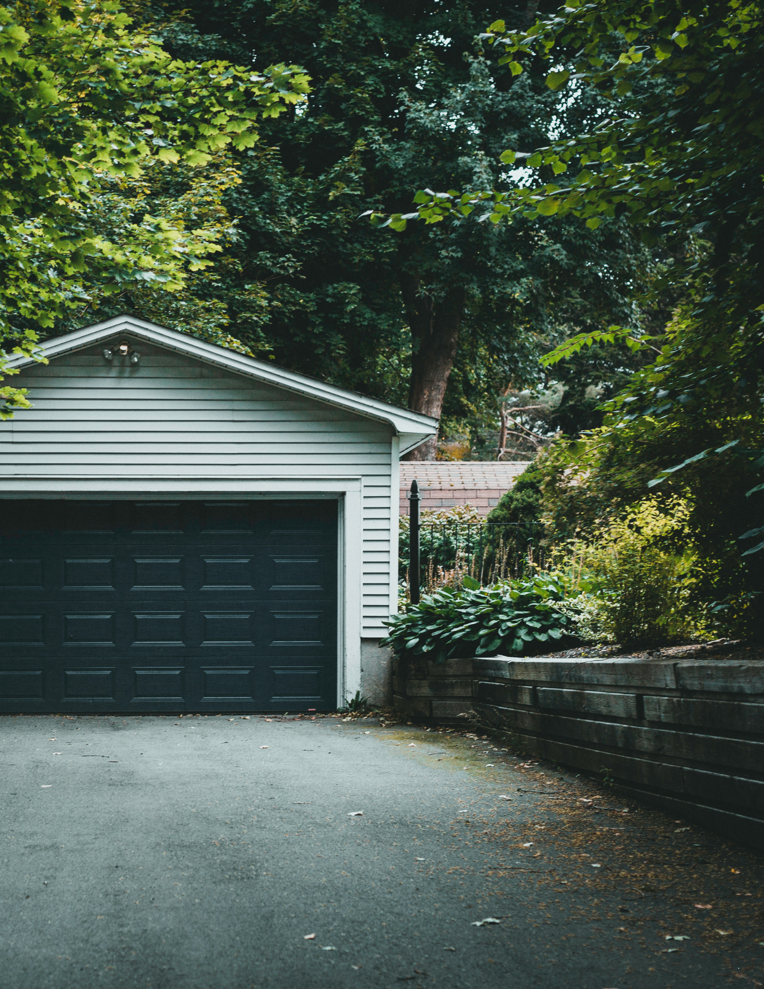 Home exterior with garage and driveway needing pressure washing service