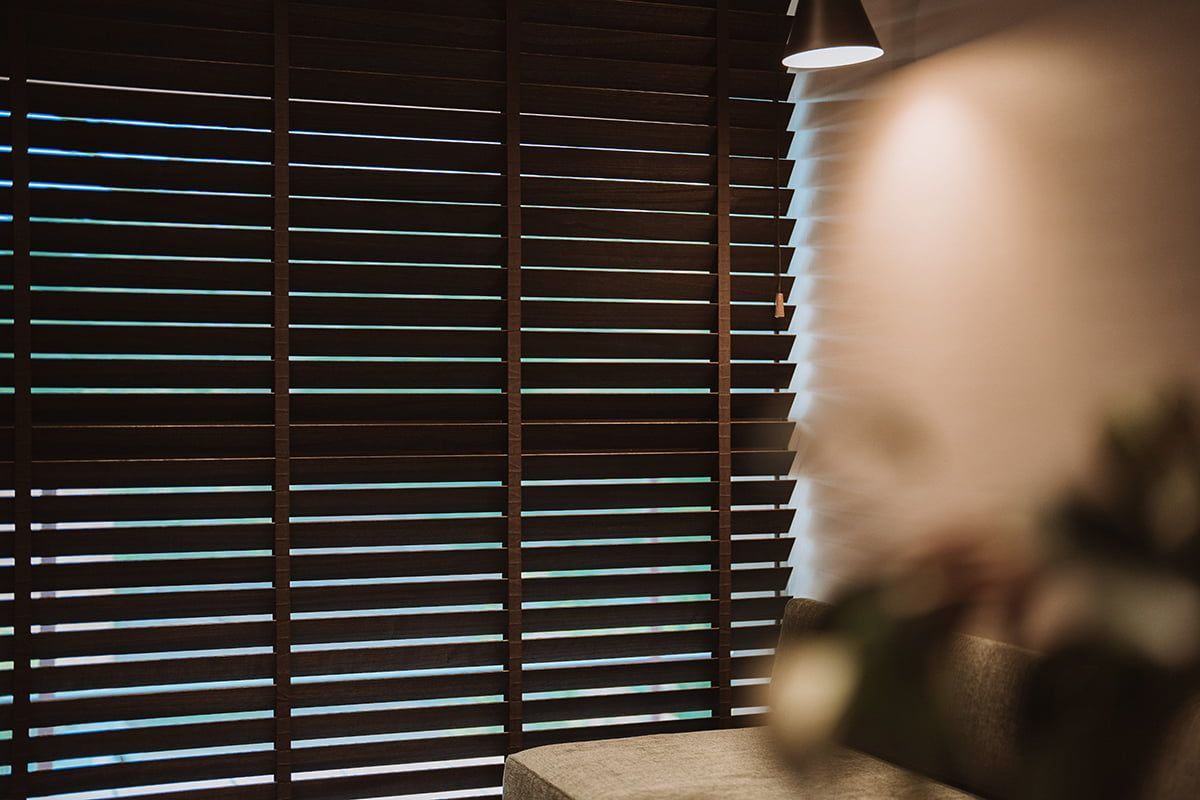 Dark Wood Blinds Partially Cover a Window — LeSands Screens & Blinds Moss Vale Pty Ltd in Moss Vale, NSW