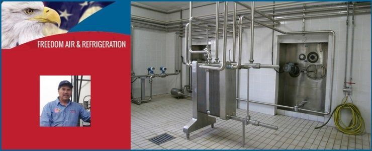 Red panel with man’s portrait beside industrial equipment and stainless steel pipes in a tiled room