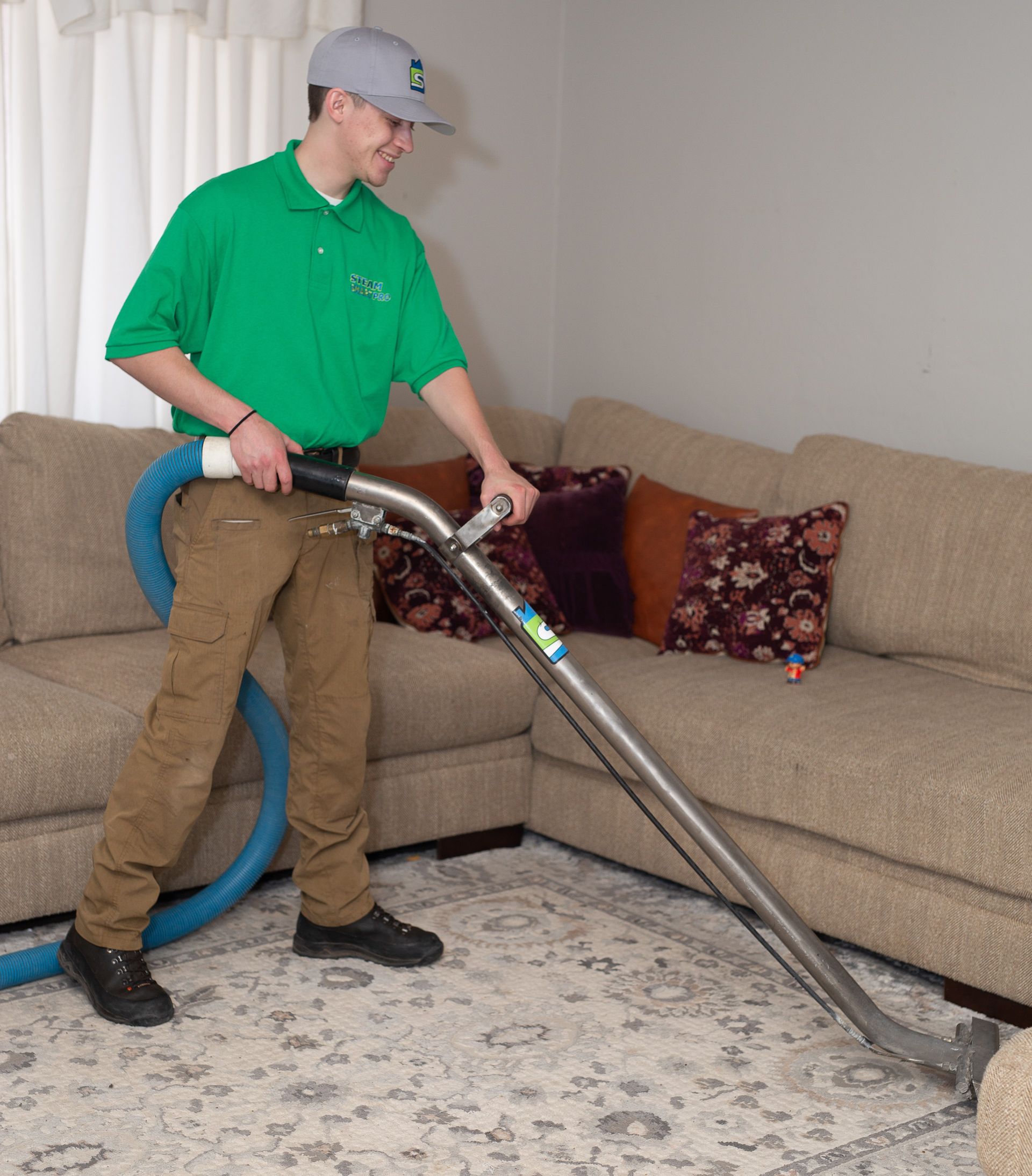'steam smart pro' carpet cleaning technician cleaning carpet using a carpet wand extractor