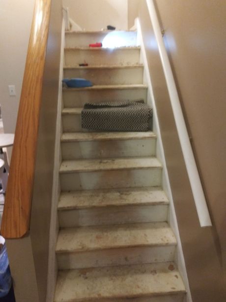 A set of stairs with a wooden railing