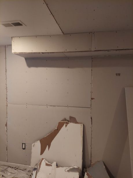 A room with a lot of boxes on the floor and a ceiling.