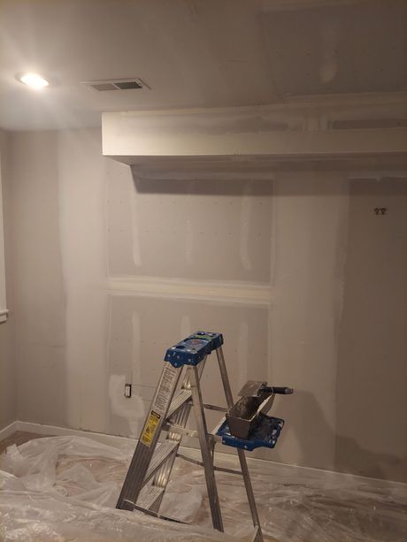 A ladder is sitting on the floor in a room.