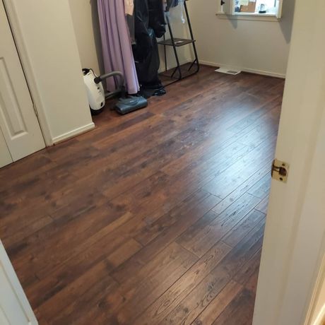 A room with a wooden floor and a white door