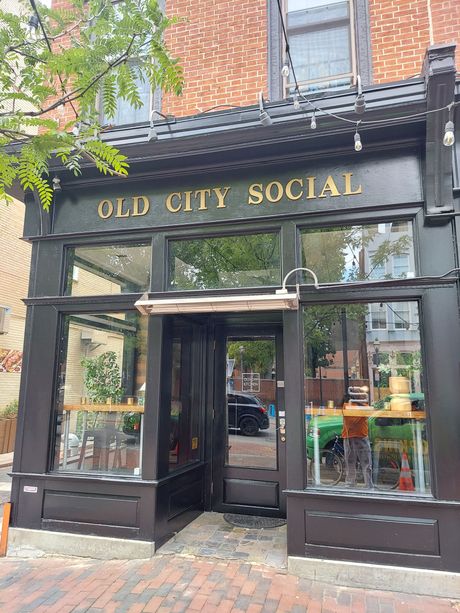 The old city social restaurant is located on a brick building.
