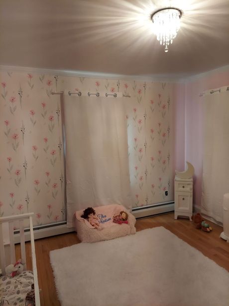A child is sleeping on a bean bag chair in a room.