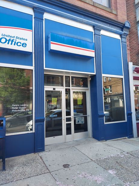 A blue and white building with a sign that says united states office