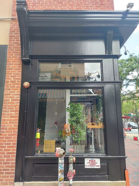 A brick building with a black door and a window.