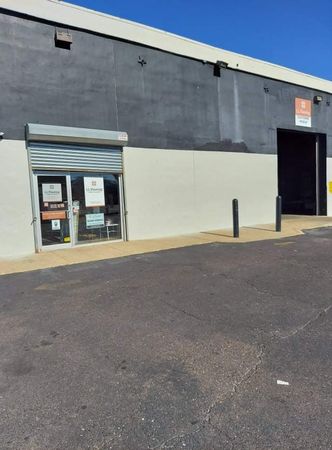 A black and white building with a garage door