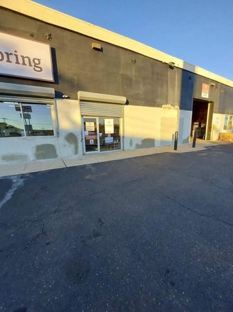 A building with a sign that says ' flooring ' on it
