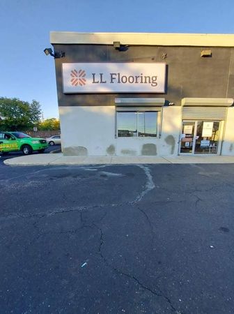 A building with a sign that says ll flooring