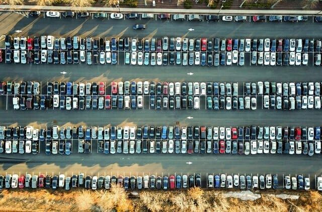 An aerial view of a parking lot filled with cars