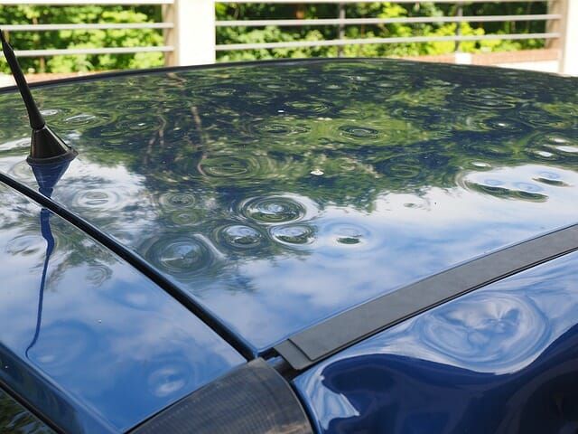 A close up of a car 's roof with hail damage