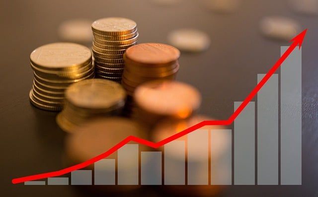 A bunch of coins stacked on top of each other with a graph in the background.