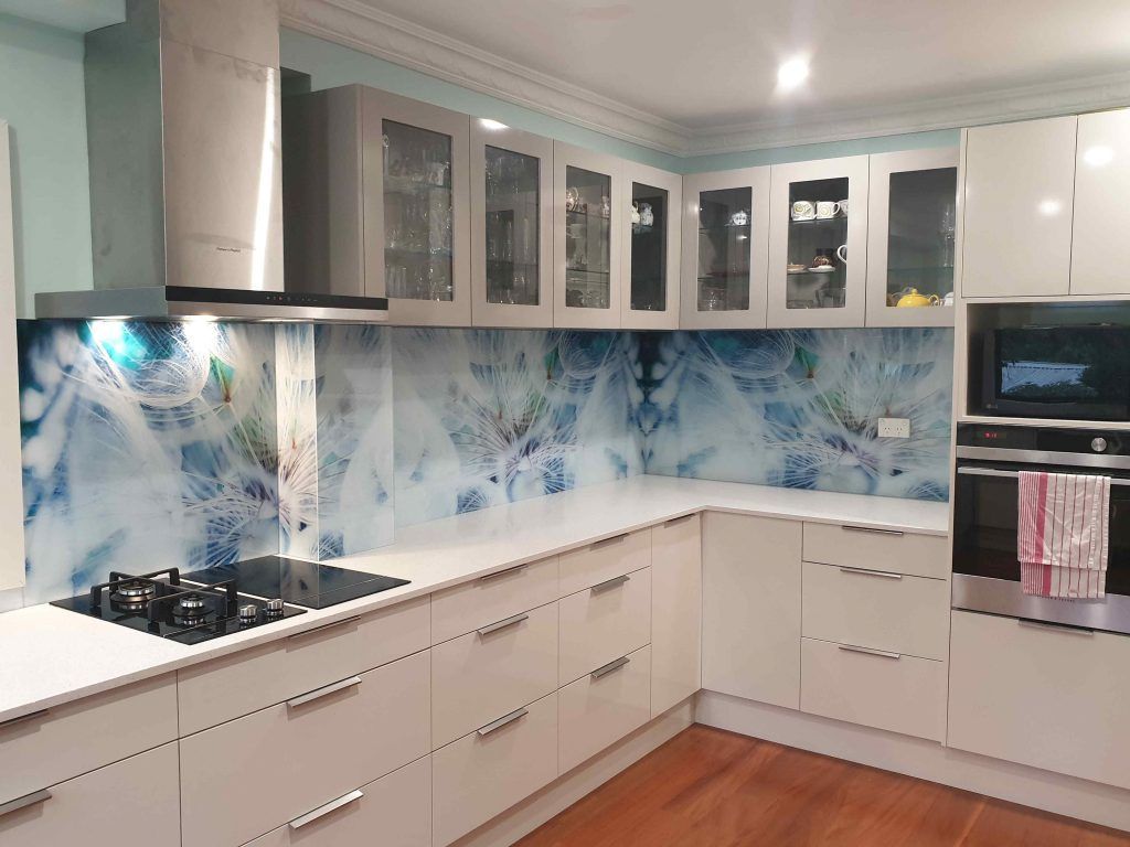 A Kitchen with White Cabinets, Stainless Steel Appliances , and A Stove Top Oven — DecoGlaze in Lake Macquarie, NSW