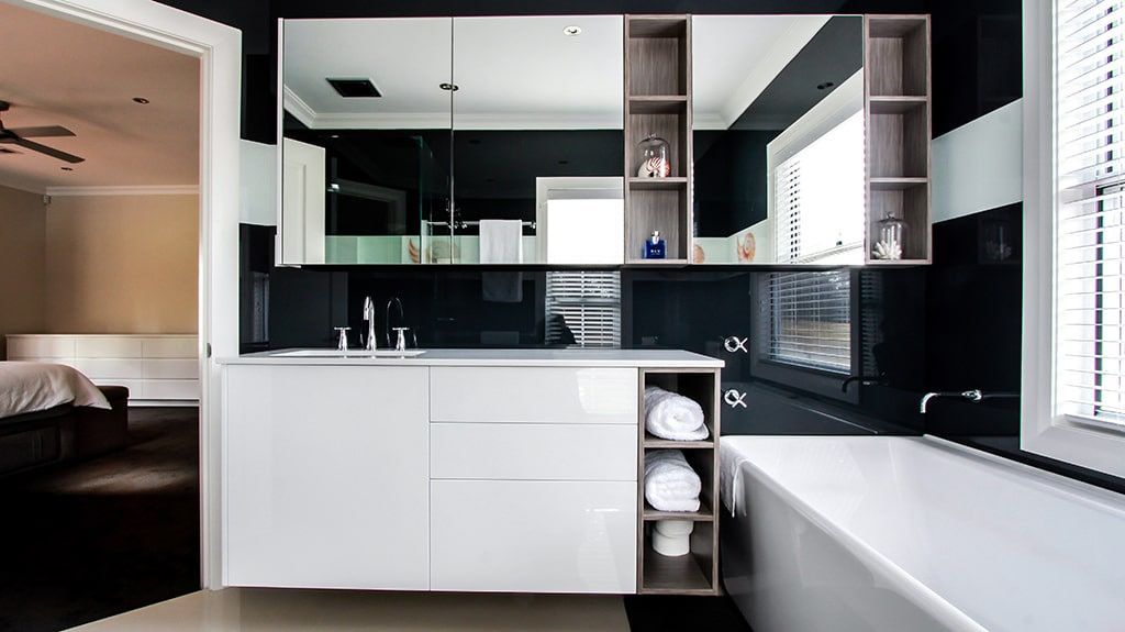 A Bathroom with Black and White Tiles and A Bathtub — DecoGlaze in Newcastle, NSW