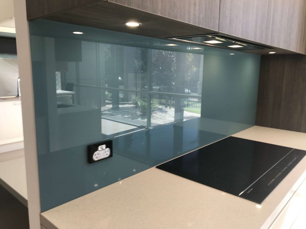 A Kitchen with A Blue Glass Backsplash and A Black Stove Top Oven — DecoGlaze in Port Stephens, NSW