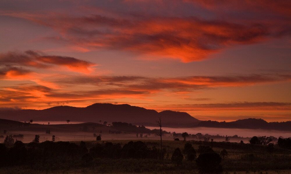 A Sunset Over a Field with Mountains in The Background — DecoGlaze in Singleton, NSW
