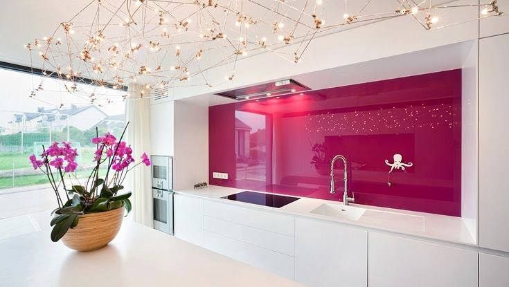 A Kitchen with A Purple Wall and White Cabinets and A Vase of Flowers on The Counter — DecoGlaze in Cardiff, NSW