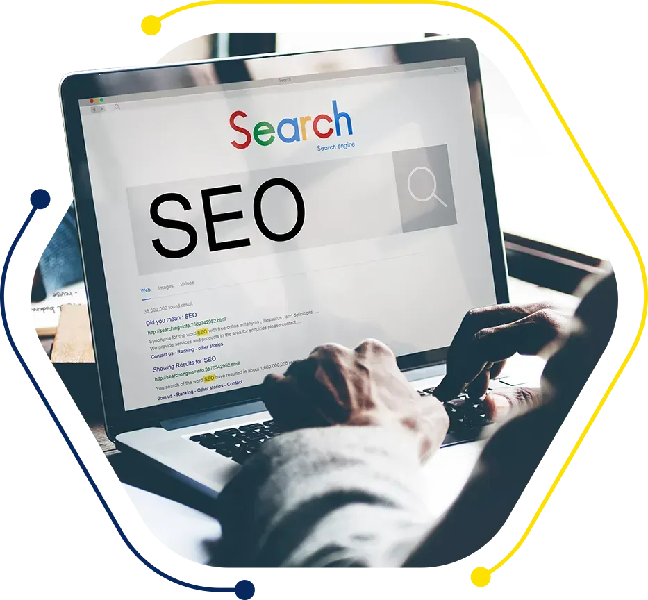a person is typing on a laptop that says search on the screen