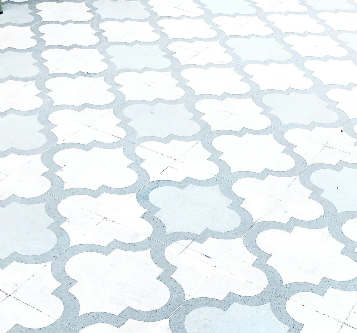 White and light blue patterned tile flooring.