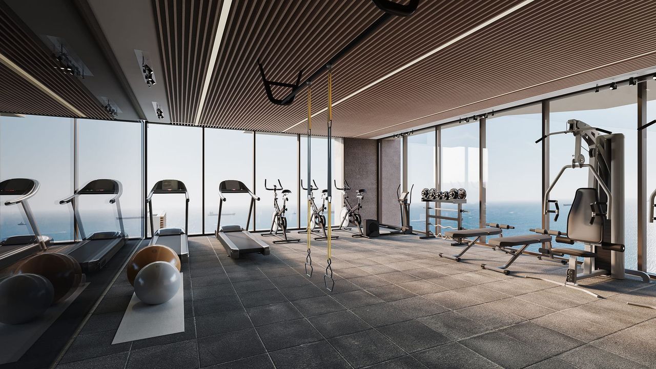 Hotel con gimnasio en Santa Marta con caminadoras, pesas, ventanales y techo ondulado en Nuruma Suites by Emerawa