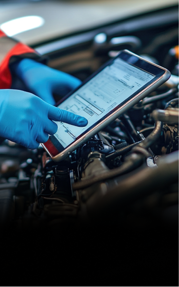 Technician performing diagnostics for vehicle, reviewing screen with details | Four Seasons Tire & Auto Service