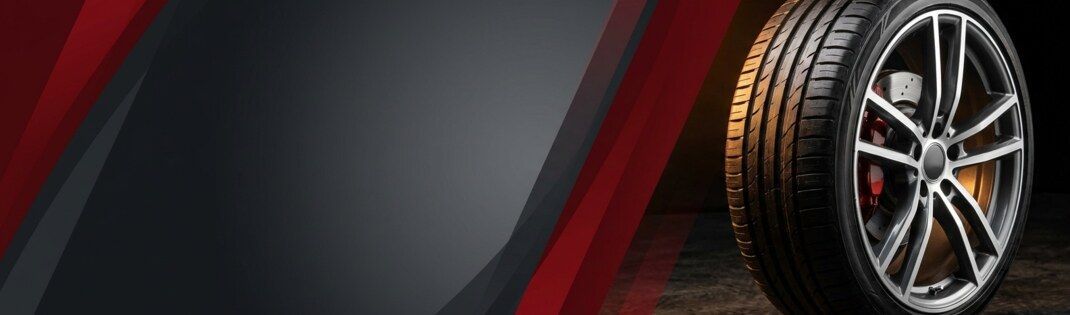 Tire and alloy wheel on a red and charcoal background | Four Seasons Tire & Auto Service
