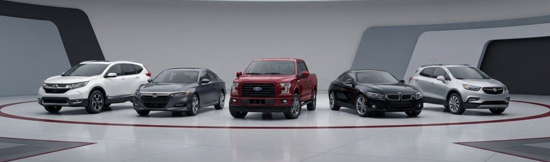 Red, white, black, and gray vehicles in a row | Four Seasons Tire & Auto Service