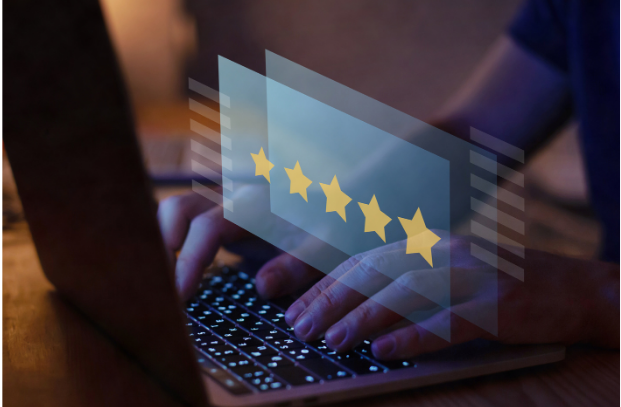 Hands typing on a laptop with a translucent 5-star rating graphic over the screen