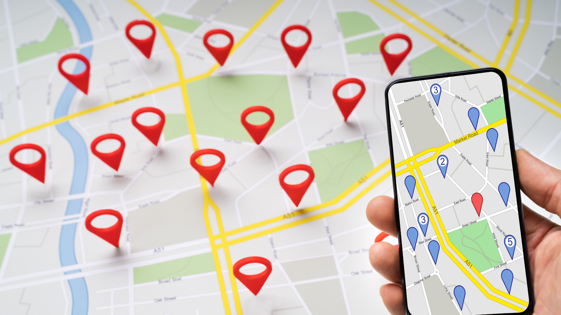 Hand holding smartphone showing map with location pins on a city map background
