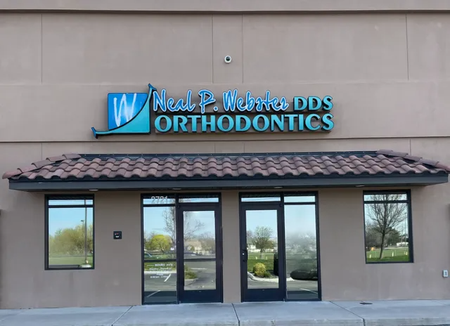 Exterior of Neal P. Webster, DDS Orthodontics office with signage over glass doors and windows.