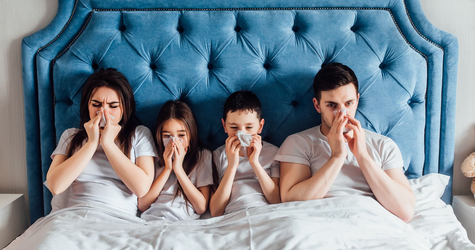 macromed. pharmaceutical compnanies in lebanon. rabih hassouneh. A family is laying in bed blowing their noses with tissues.