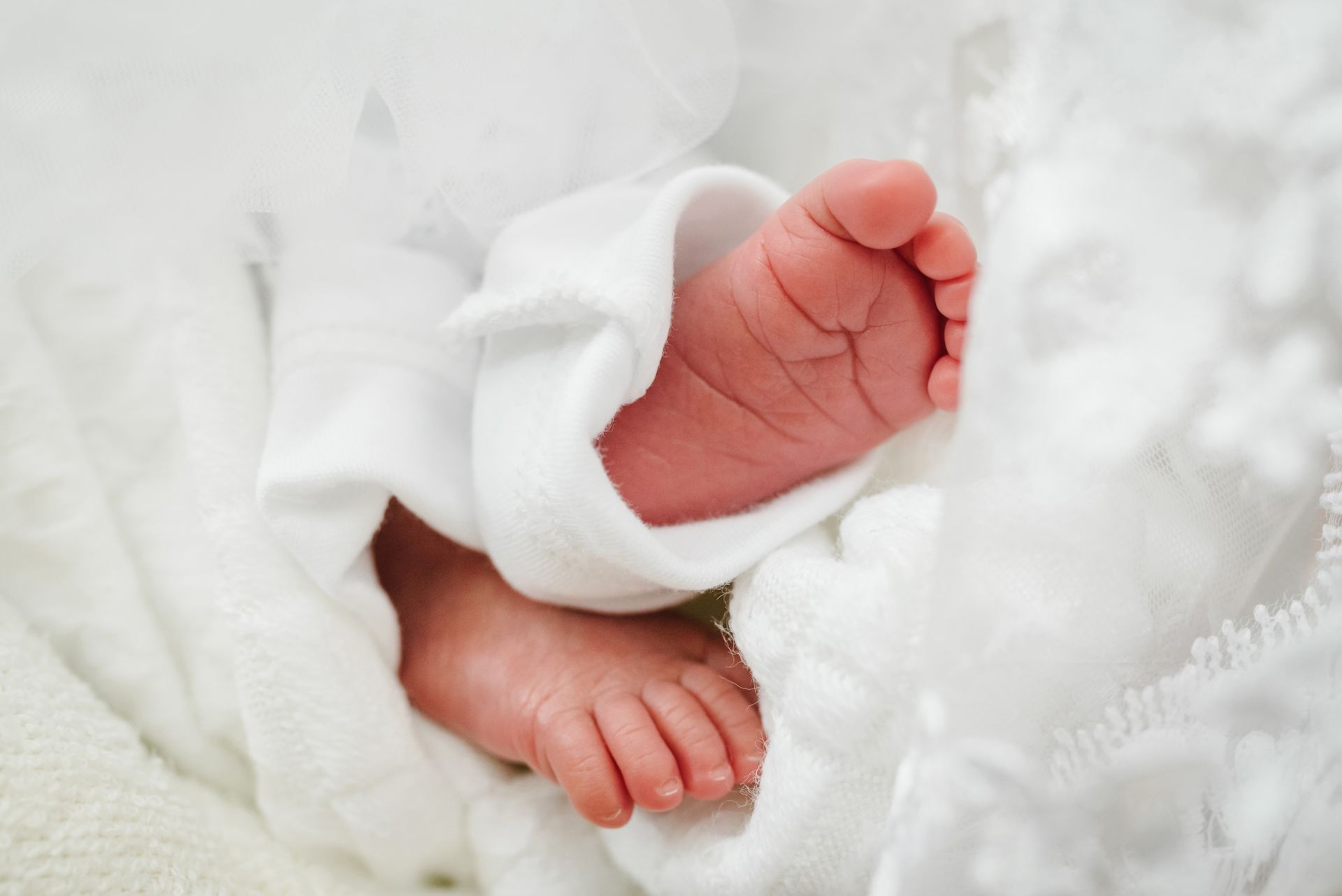 macromed. pharmaceutical compnanies in lebanon. rabih hassouneh. A close up of a baby 's feet wrapped in a white blanket.