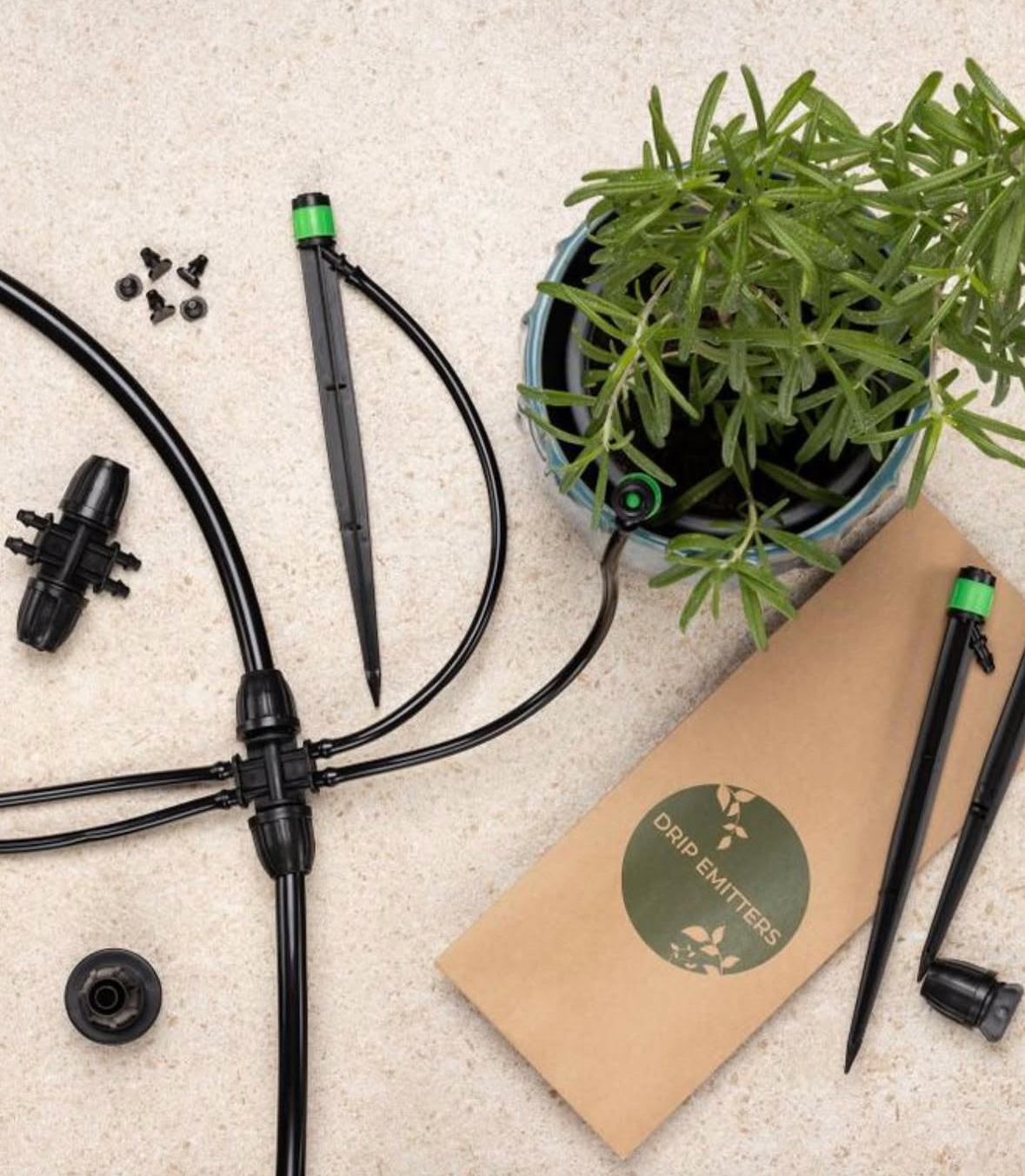 A drip irrigation kit with tubing, stakes, and connectors, shown with a potted plant on a neutral surface.