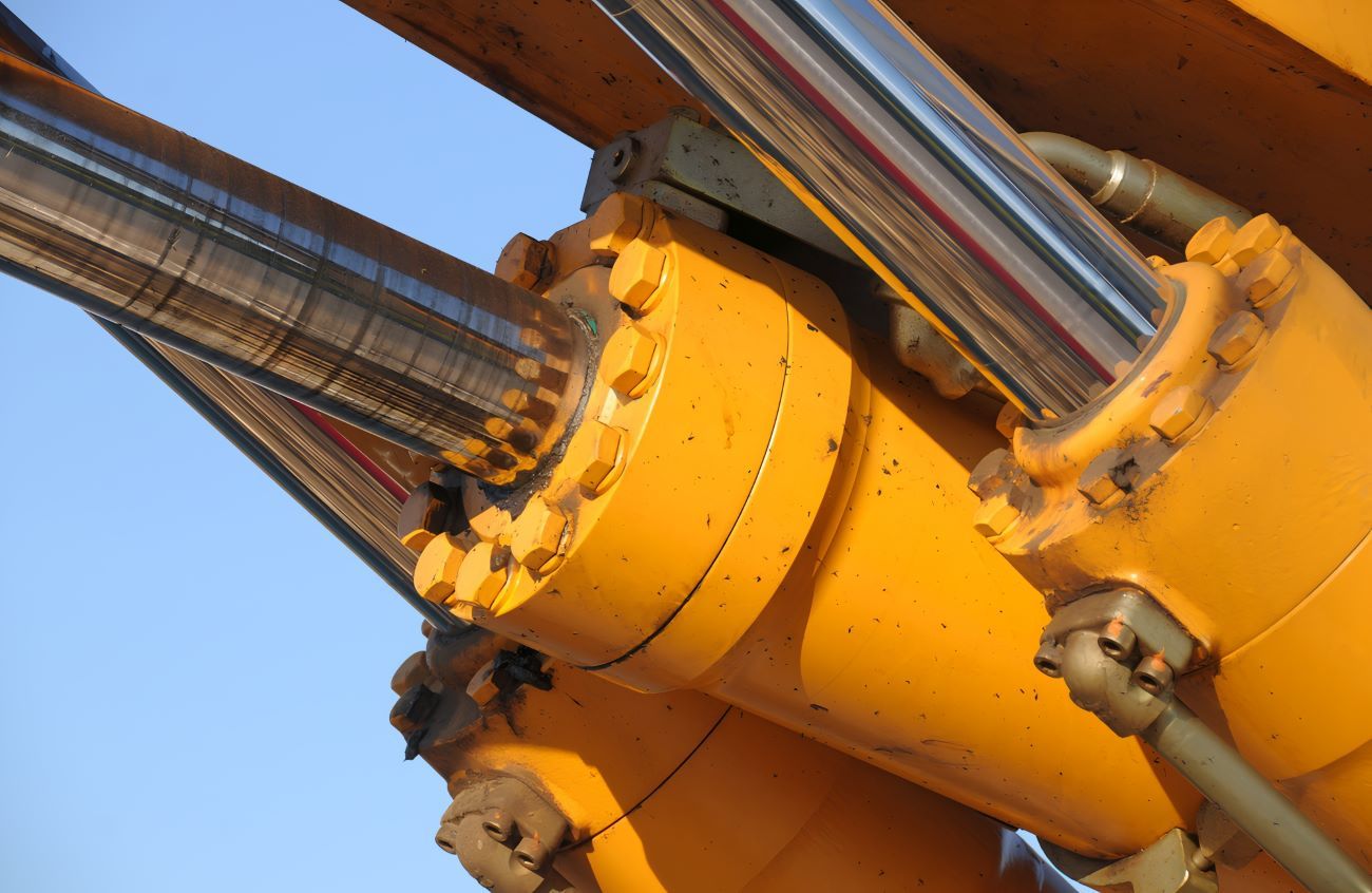 A Close up Of a Yellow Hydraulic Cylinder on A Machine — Berkeley Vale Hydraulics in Fountaindale, NSW